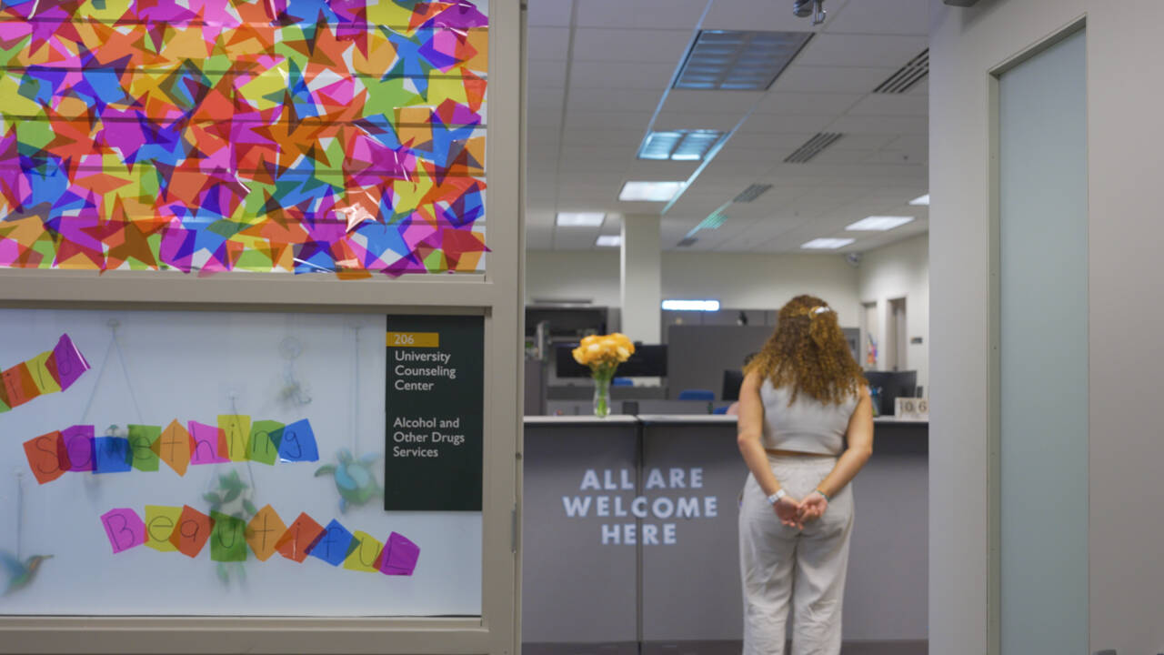student standing at the University Counseling Center front desk